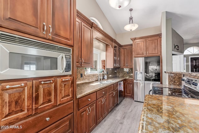 24813 N 55th Dr, Glendale, AZ 85310 - kitchen featuring appliances with stainless steel finishes, a sink, lofted ceiling, tasteful backsplash, and light wood-type flooring