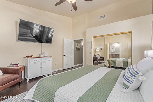 24813 N 55th Dr, Glendale, AZ 85310 - bedroom featuring dark wood-style flooring, ceiling fan, a closet, baseboards, and a towering ceiling