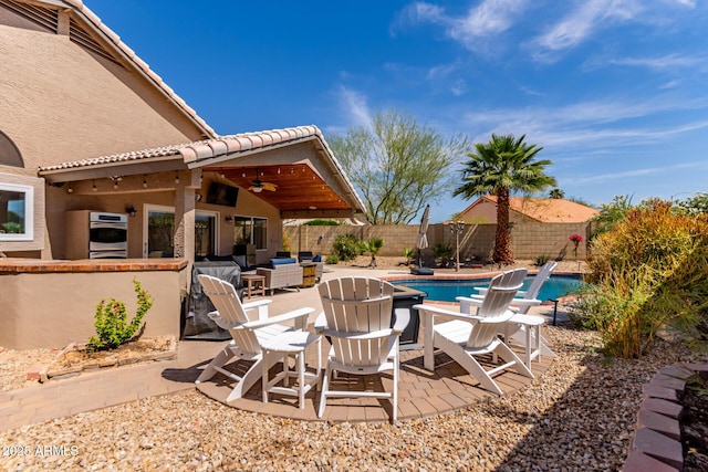 24813 N 55th Dr, Glendale, AZ 85310 - fenced backyard with a ceiling fan, an outdoor living space, and a patio area