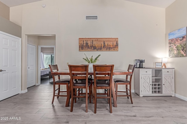 24813 N 55th Dr, Glendale, AZ 85310 - dining area with light wood-type flooring, vaulted ceiling, and baseboards