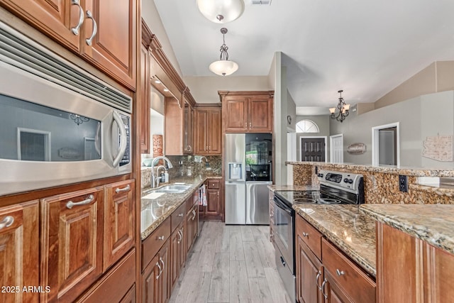 24813 N 55th Dr, Glendale, AZ 85310 - kitchen with appliances with stainless steel finishes, brown cabinetry, and tasteful backsplash