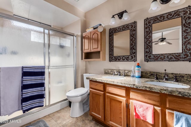 full bath with double vanity, a shower stall, toilet, and a sink
