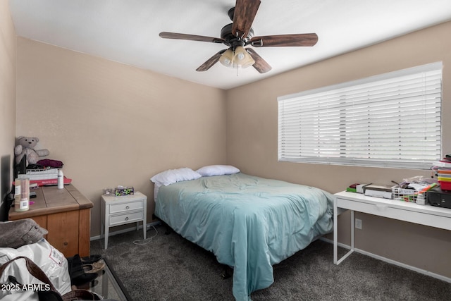 carpeted bedroom with ceiling fan and baseboards