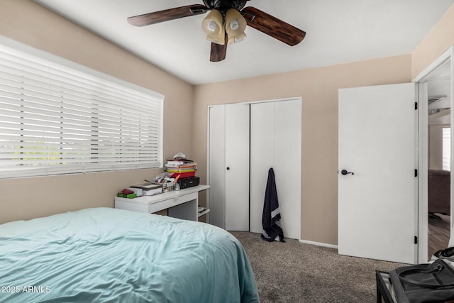 carpeted bedroom featuring a ceiling fan and a closet