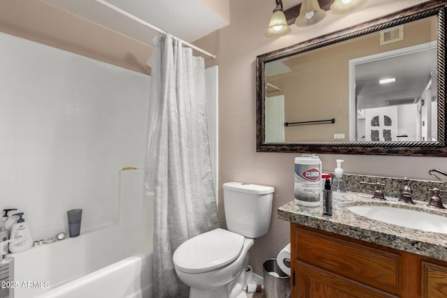 bathroom with shower / bath combo with shower curtain, visible vents, vanity, and toilet