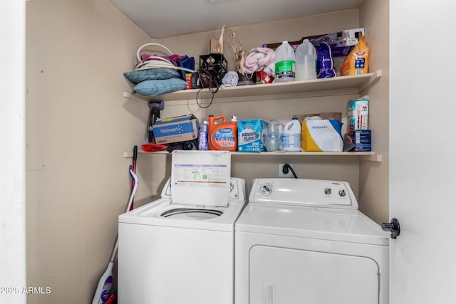 clothes washing area with separate washer and dryer and laundry area