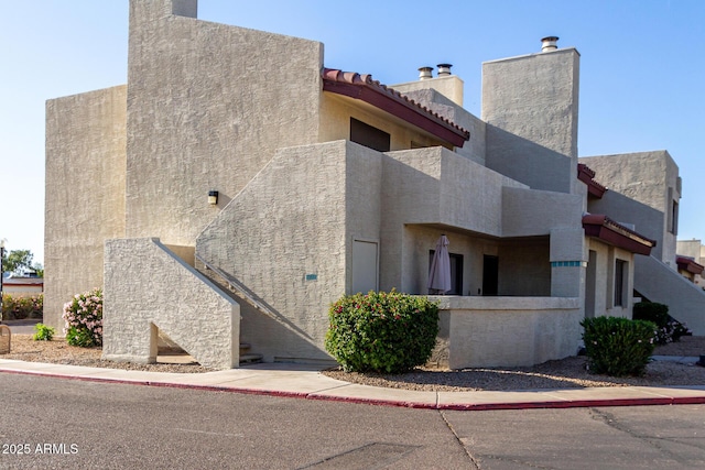 view of home's exterior featuring a chimney and stucco siding