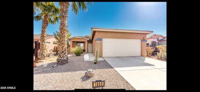 view of front of property with a garage, driveway, and stucco siding