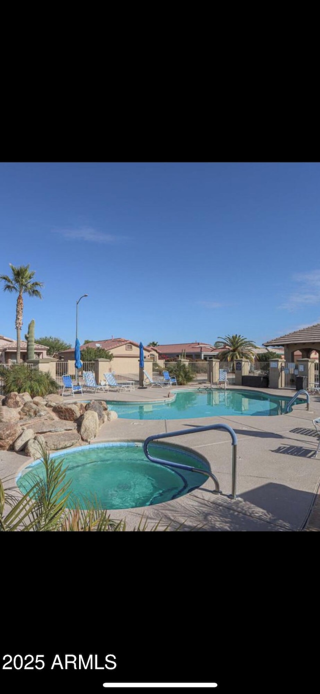1869 E Birch St, Casa Grande, AZ 85122 - community pool featuring a patio, fence, and a community hot tub