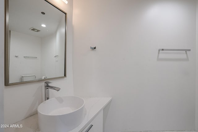 bathroom featuring vanity and toilet