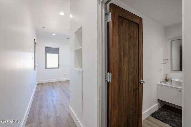 corridor with light hardwood / wood-style flooring