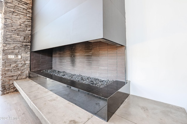 kitchen featuring a towering ceiling, light hardwood / wood-style flooring, and tasteful backsplash