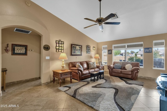 tiled living room with ceiling fan and vaulted ceiling