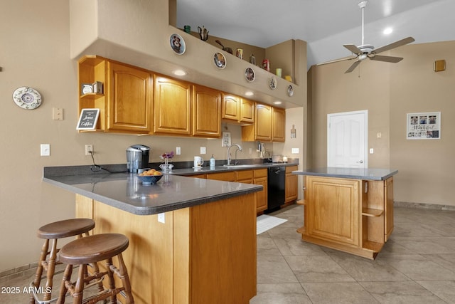 kitchen with a kitchen island, black dishwasher, sink, ceiling fan, and kitchen peninsula