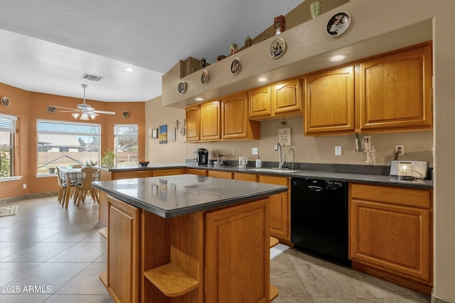 kitchen featuring sink, a center island, light tile patterned floors, black dishwasher, and ceiling fan