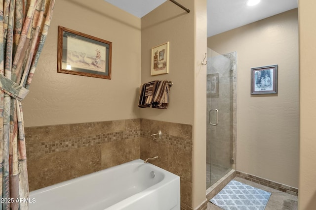 bathroom with shower with separate bathtub and tile patterned floors