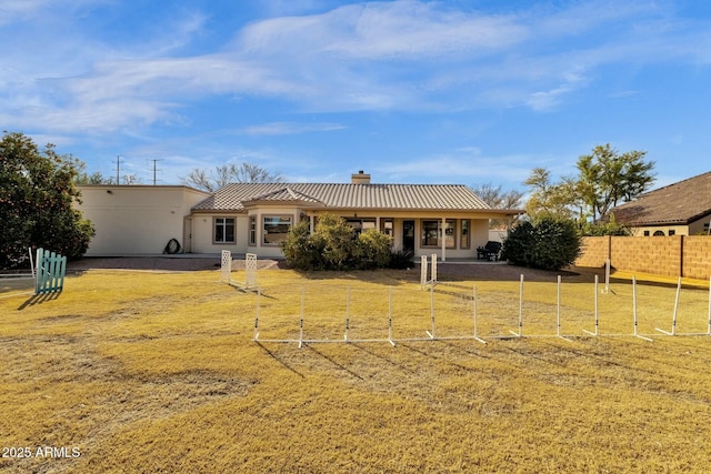 back of property featuring a lawn