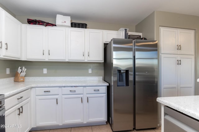 1706 W Coolidge Way, Coolidge, AZ 85128 - kitchen with stainless steel fridge, light tile patterned flooring, and white cabinets