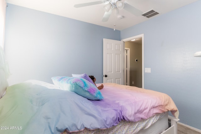 bedroom with ceiling fan and carpet floors