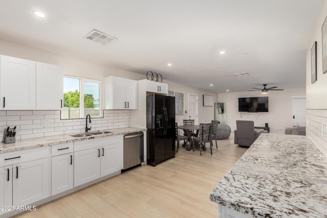 kitchen featuring black fridge, a sink, ceiling fan, dishwasher, and visible vents