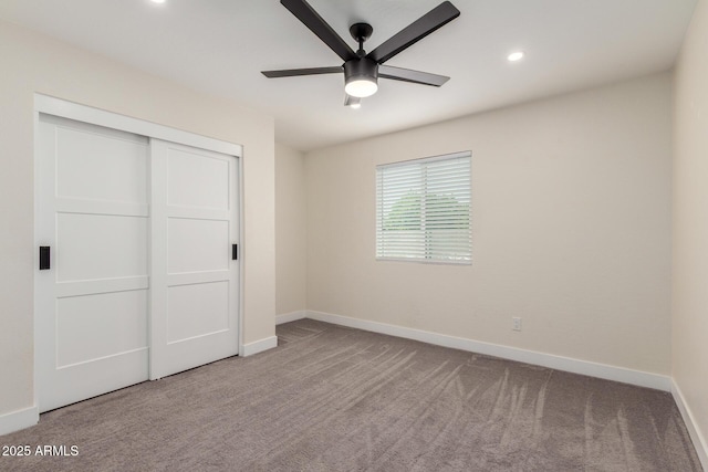 unfurnished bedroom with recessed lighting, carpet, baseboards, a ceiling fan, and a closet