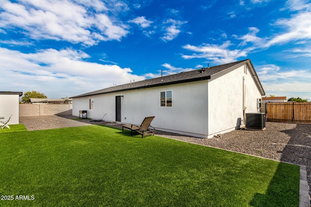 back of house featuring a fenced backyard, a lawn, a patio area, and central AC unit
