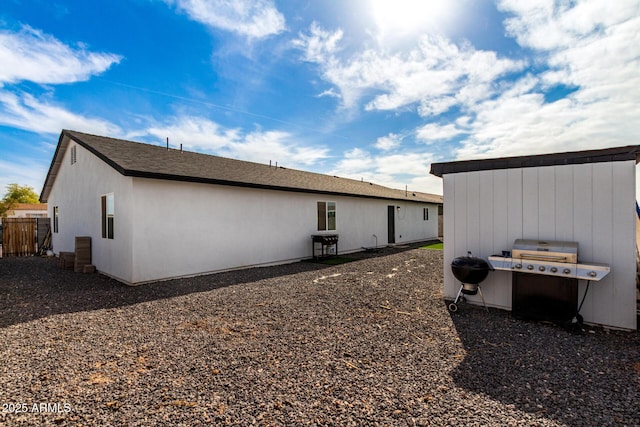 back of property featuring fence