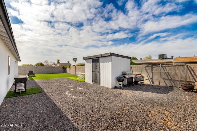 view of yard featuring a fenced backyard, an outdoor fire pit, and an outdoor structure