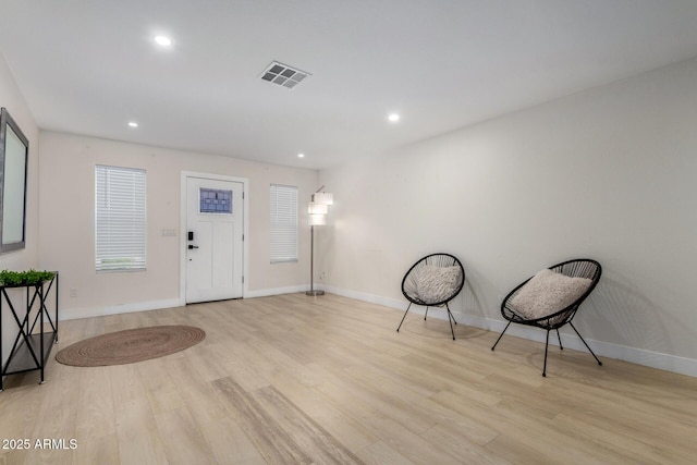 sitting room featuring baseboards, visible vents, wood finished floors, and recessed lighting