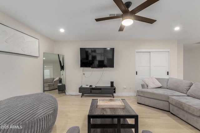 living area with light wood-type flooring, visible vents, ceiling fan, and recessed lighting