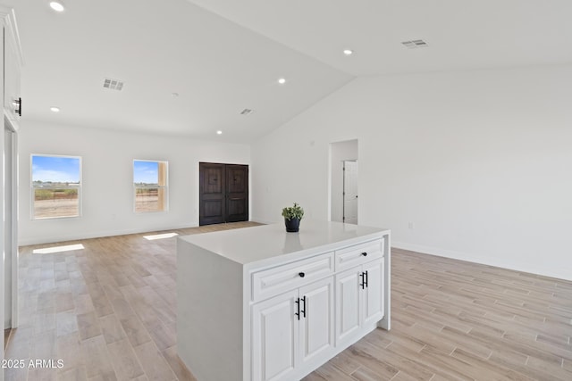 1222 S 365th Ave, Tonopah, AZ 85354 - kitchen with open floor plan, vaulted ceiling, light wood-style flooring, baseboards, and recessed lighting