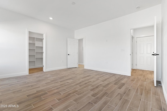 1222 S 365th Ave, Tonopah, AZ 85354 - empty room with light wood-style floors, baseboards, a smoke detector, and recessed lighting