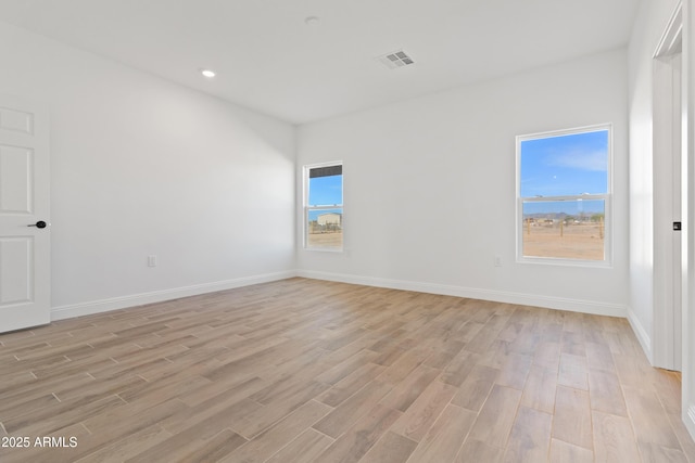 1222 S 365th Ave, Tonopah, AZ 85354 - spare room featuring light wood-style flooring, plenty of natural light, baseboards, and recessed lighting