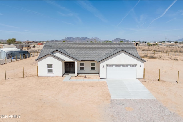 1222 S 365th Ave, Tonopah, AZ 85354 - ranch-style house with driveway, stucco siding, an attached garage, and a tile roof