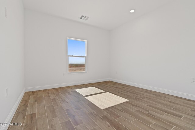 1222 S 365th Ave, Tonopah, AZ 85354 - spare room featuring wood finished floors, baseboards, and recessed lighting