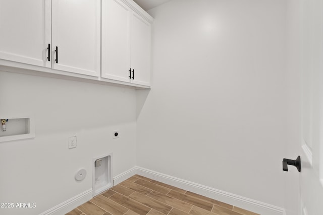 1222 S 365th Ave, Tonopah, AZ 85354 - laundry room featuring cabinet space, electric dryer hookup, baseboards, gas dryer hookup, and wood finished floors
