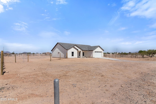 1222 S 365th Ave, Tonopah, AZ 85354 - modern farmhouse style home with a garage, driveway, a view of rural / pastoral area, and stucco siding