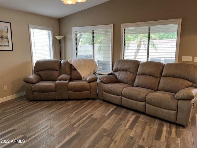 living room featuring hardwood / wood-style flooring, plenty of natural light, and lofted ceiling