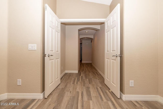 corridor with light hardwood / wood-style floors