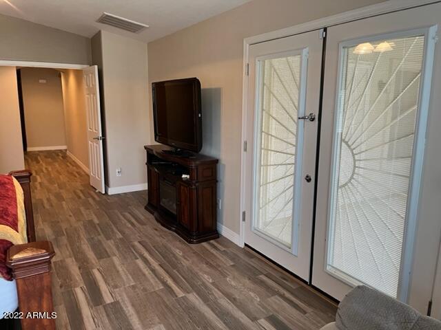 doorway with french doors and dark wood-type flooring