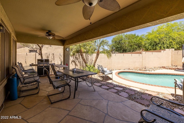 view of patio featuring a fenced in pool, grilling area, and ceiling fan