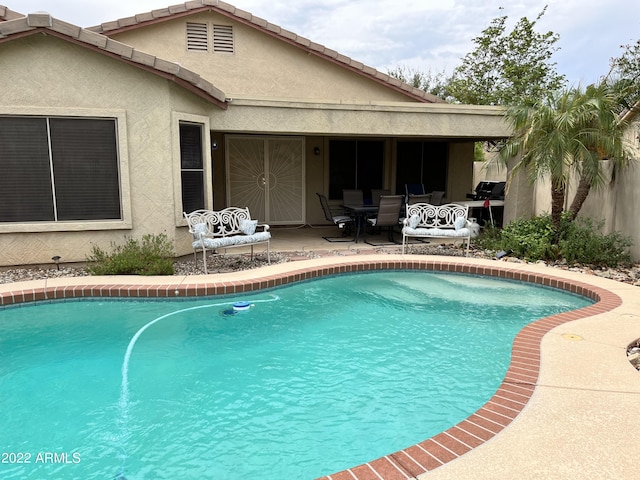 view of swimming pool featuring a patio area