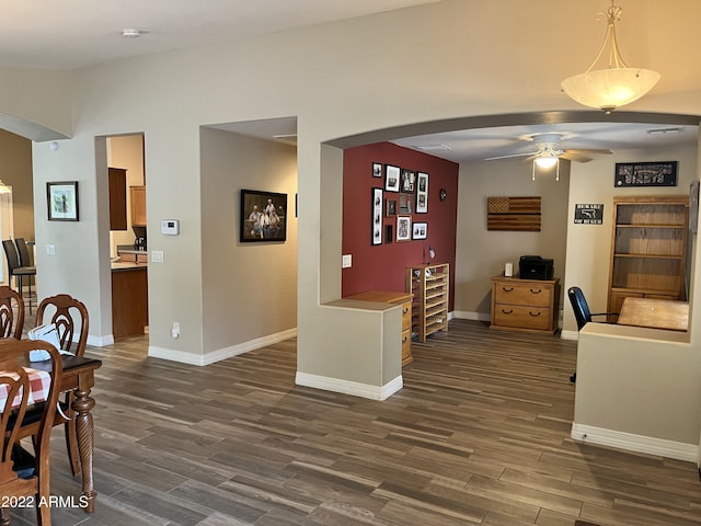 dining room with wine cooler, ceiling fan, and dark hardwood / wood-style flooring