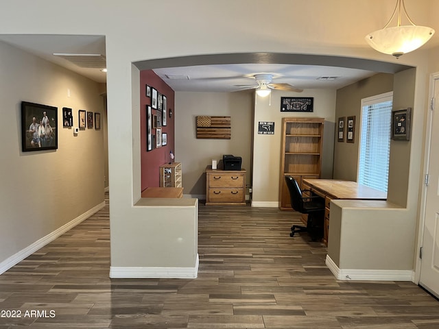 home office with ceiling fan and built in desk