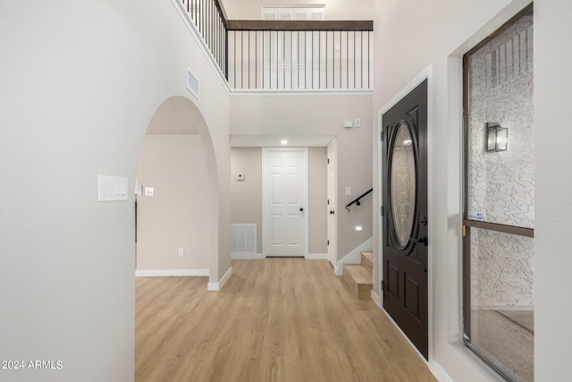 entrance foyer featuring light wood-type flooring and a high ceiling