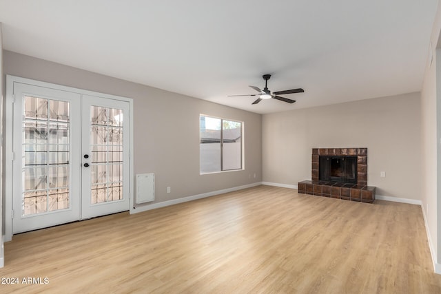 unfurnished living room with ceiling fan, french doors, and light hardwood / wood-style flooring