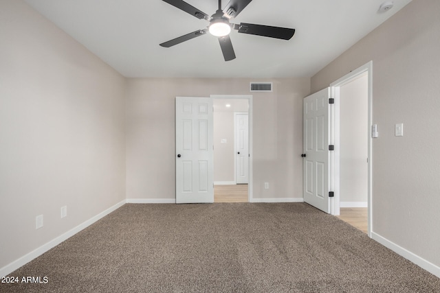 unfurnished bedroom featuring light carpet and ceiling fan