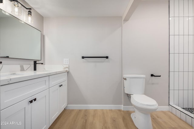 bathroom with vanity, hardwood / wood-style flooring, and toilet