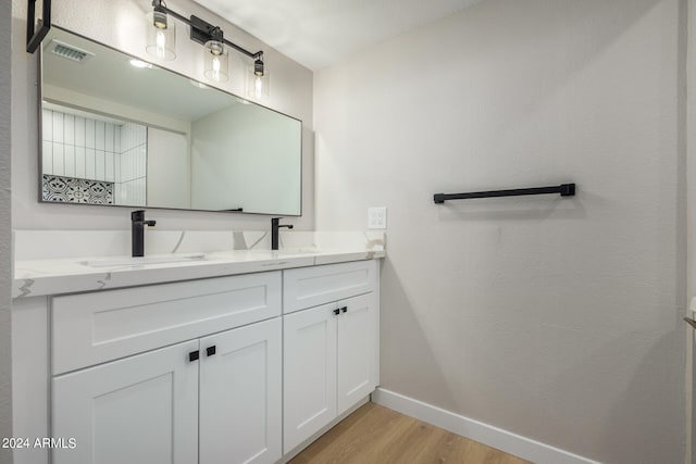 bathroom with hardwood / wood-style floors and vanity