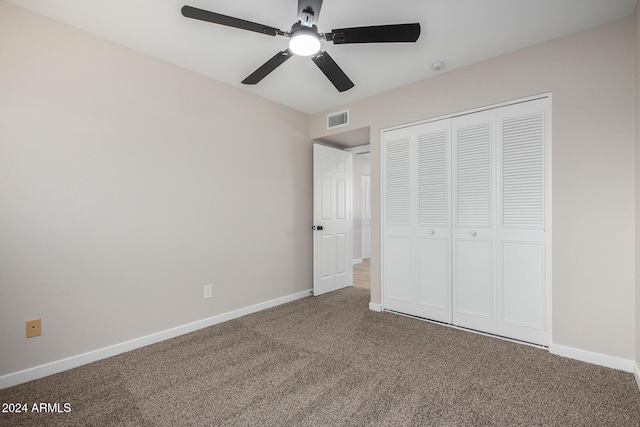 unfurnished bedroom featuring ceiling fan, a closet, and carpet flooring